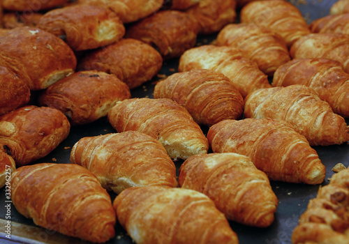 Close up fresh baked croissants on retail display