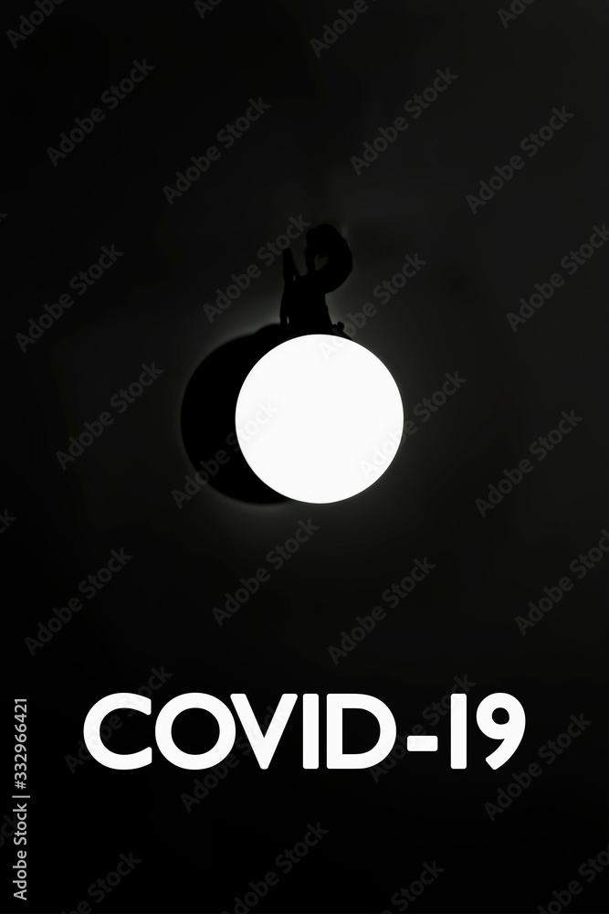 Covid-19. White round lamp shines, weighs on the ceiling