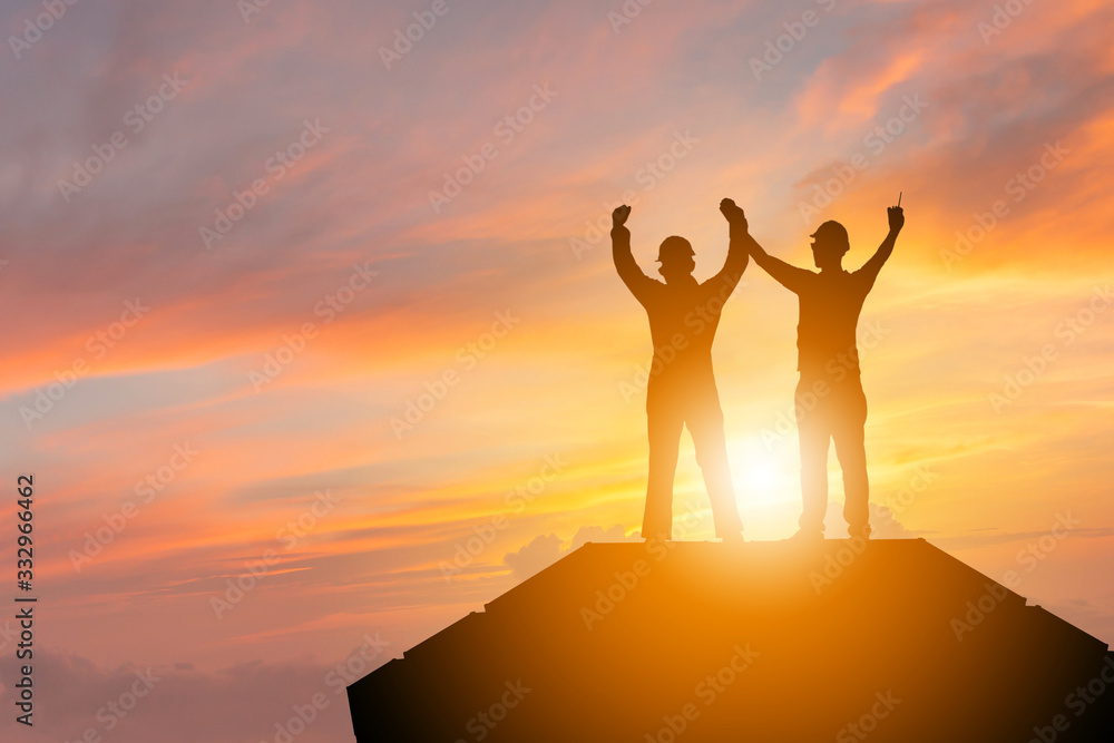 Silhouette of Business engineer man with clipping path celebration success happiness on container box evening sky sunset background, Teamwork Concept