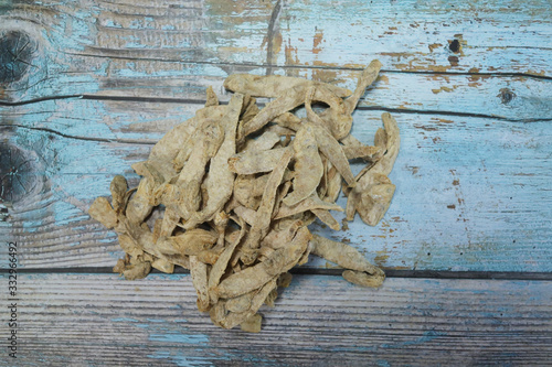 pickled fish is made by drying and meddling with salt on a wooden background