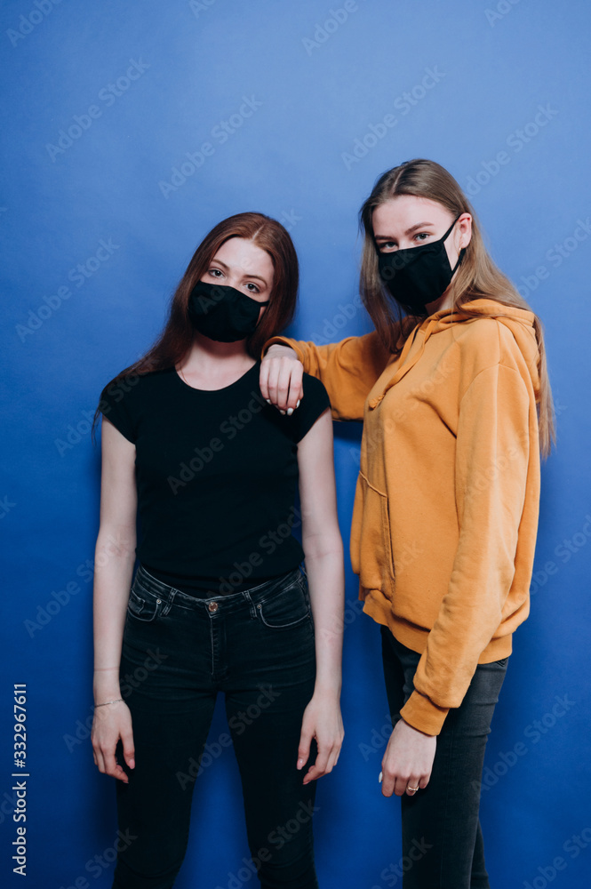 beautiful girl in an antiviral mask on a blue background beautiful girl in an antiviral mask on a blue background