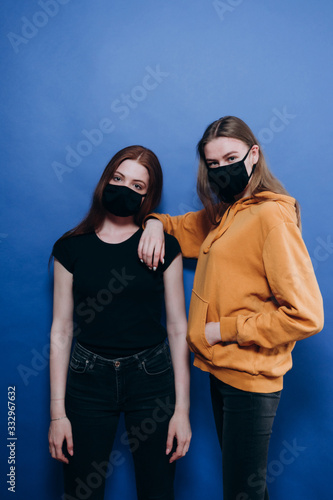 beautiful girl in an antiviral mask on a blue background