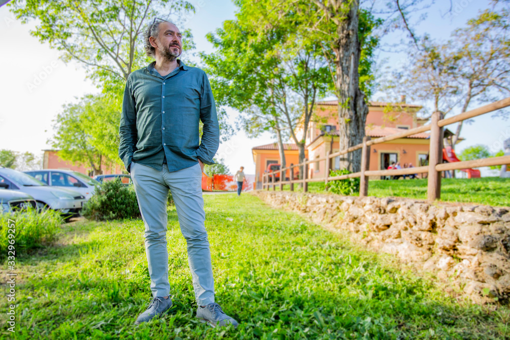 Fototapeta premium Man in a garden looks at the view