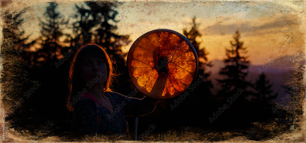 Εκτύπωση καμβά beautiful shamanic girl playing on shaman frame drum in the nature, old photo effect
