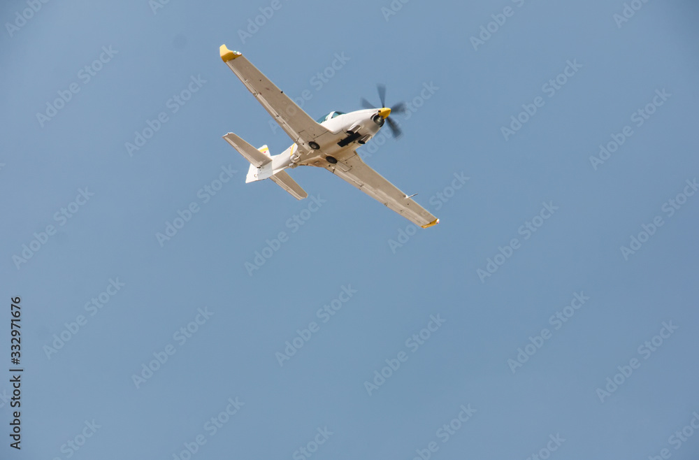 Display of a flying plane in the beautiful blue sky Display of a flying plane in the beautiful blue sky