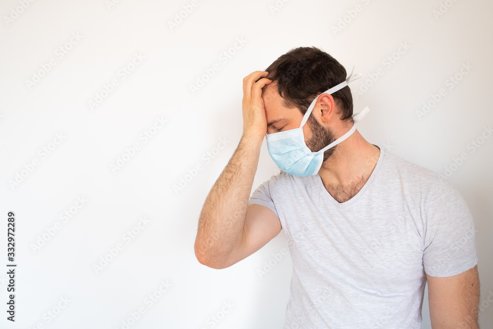 Young man wearing a biomedical mask desperate about the epidemy crisis Young man wearing a biomedical mask desperate about the epidemy crisis