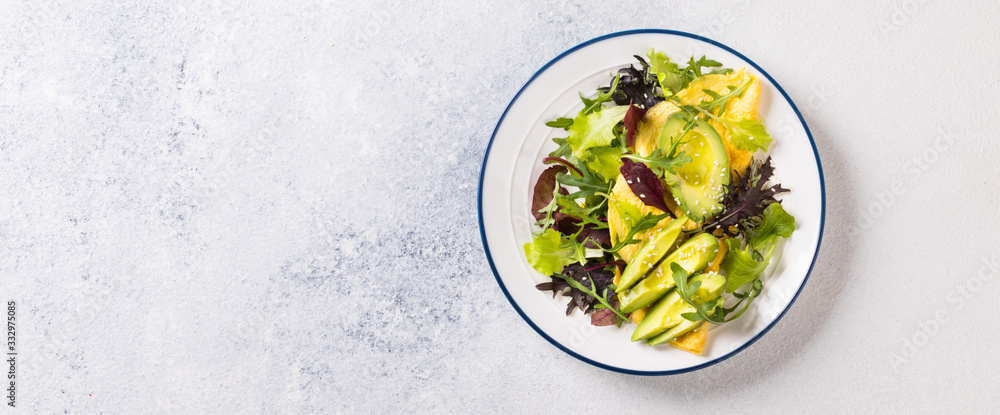 Breakfast green omelet, salad mix and avocado. Concept Healthy food in the morning. Breakfast green omelet, salad mix and avocado. Concept Healthy food in the morning.