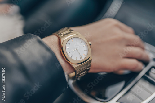 Stylish gold watch on woman hand
