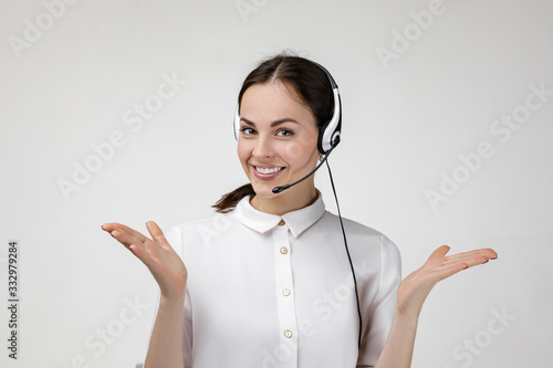 Carta da parati Beautiful smiling woman consultant of call center in headphones on gray background