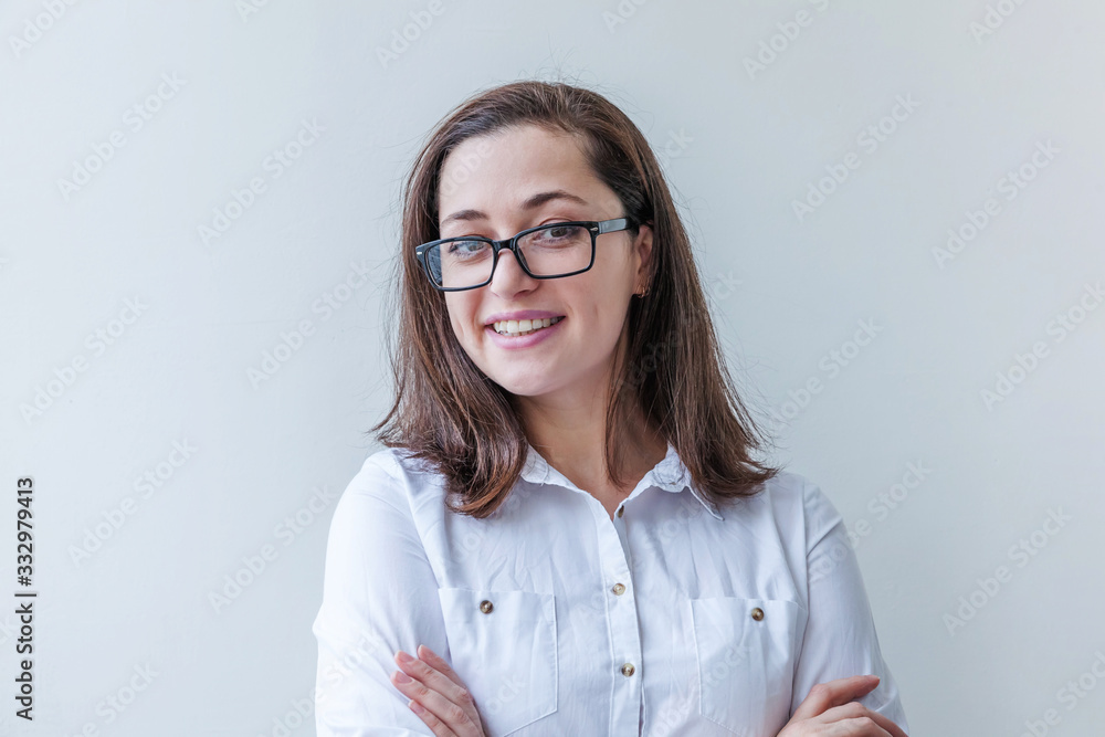 Beautiful happy girl smiling. Beauty simple portrait young smiling brunette woman in eyeglasses isolated on white background. Positive human emotion facial expression body language. Copy space Beautiful happy girl smiling. Beauty simple portrait young smiling brunette woman in eyeglasses isolated on white background. Positive human emotion facial expression body language. Copy space