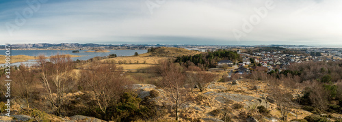 Fototapeta Naklejka Na Ścianę i Meble -  A view of Hafrsfjord fjord and Snode residential suburb from top of the hill in early spring season, Tananger, Norway, March 2018