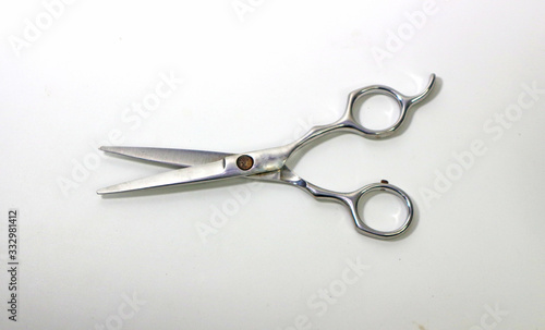 Stainless steel scissors for cutting hair,Scissors open in icon , Paper cut, white background