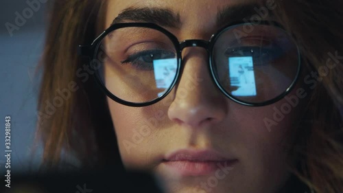 Closeup of young attractive european woman using computer touchscreen hipster girl using digital tablet device touchscreen wearing glasses busy female freelancer working at home via laptop Slow motion