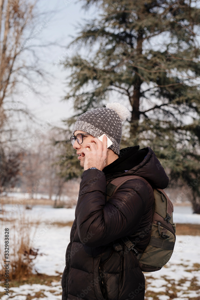 Young Male talking on the phone in winter Young Male talking on the phone in winter