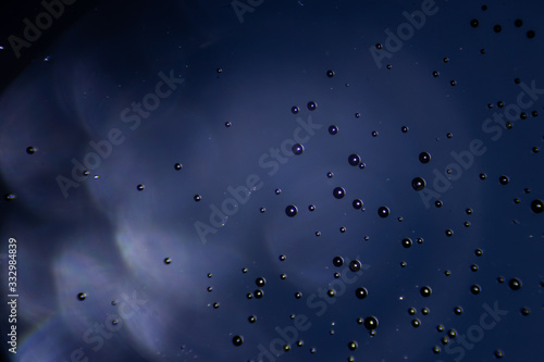 Fototapeta Naklejka Na Ścianę i Meble -  Abstract blue background. View under the microscope. Bubbles in the liquid.