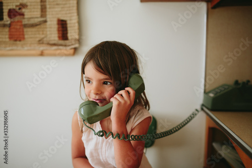 girl talks on old school phone
