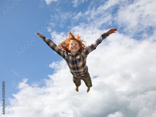 Young boy flying in the air photo