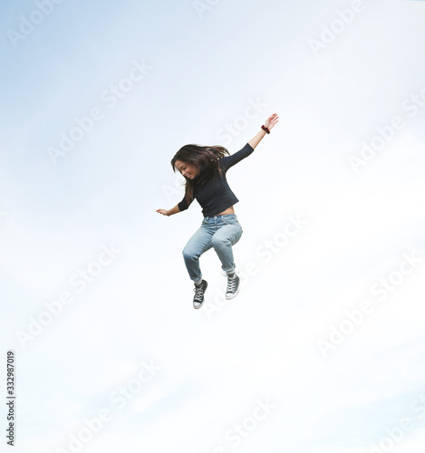 Excited jumping woman floating in mid air.
