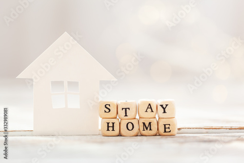 Obraz na płótnie Words stay at home made of wooden blocks and White paper house , social distanci