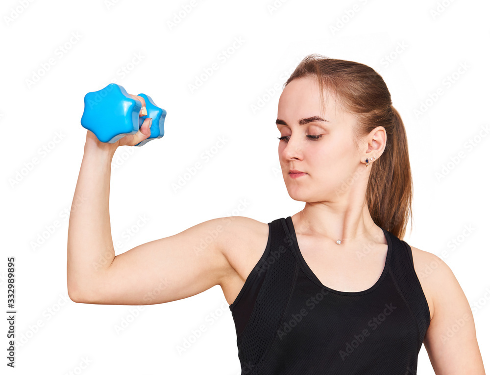 young woman performs an exercise with dumbbells looking at her biceps, isolated on white background young woman performs an exercise with dumbbells looking at her biceps, isolated on white background