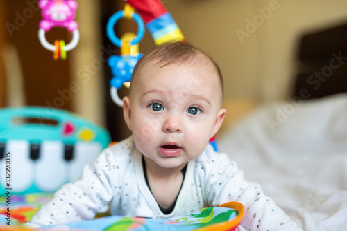 Cute six month baby playing on the bed photo