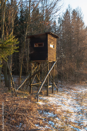Hunting tower in wild forest. Wooden Hunter Hide High watch post tower. Hunter's observation point in forest in Europe. Czech Republic
