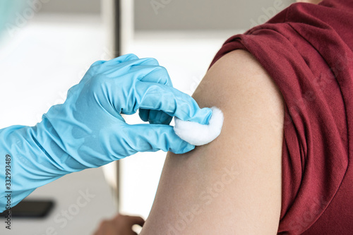 Doctor making injection vaccination patient to prevent pandemic of the disease