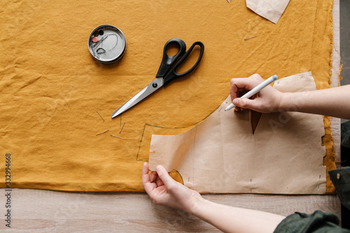 Female Tailor drawing by pencil on yellow tissue.