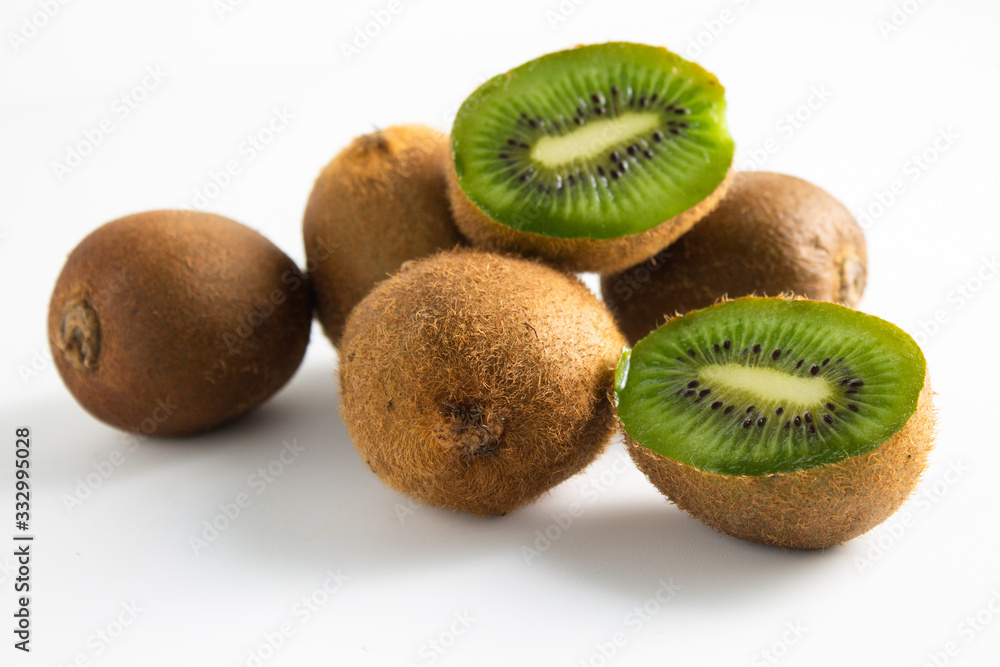 Whole and cut kiwis on white background Whole and cut kiwis on white background