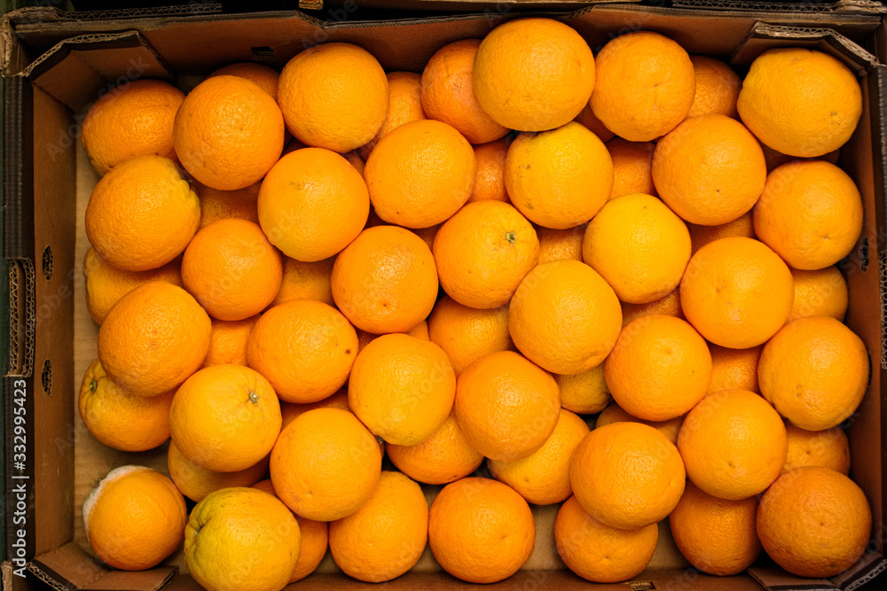 ripe oranges in a box on the market ripe oranges in a box on the market
