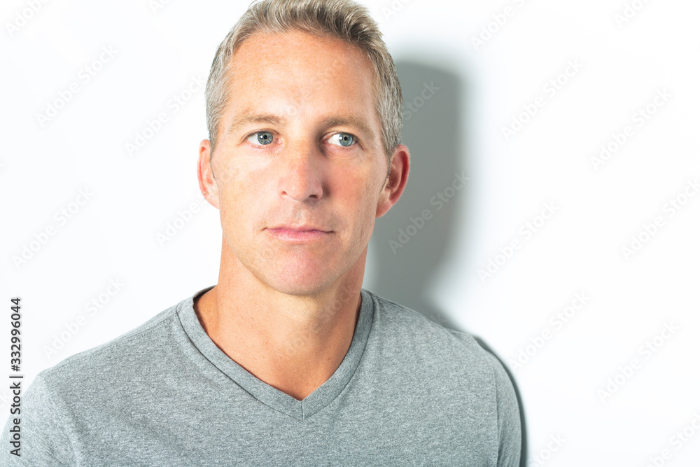 Obraz premium Portrait of confident mature man standing on white background