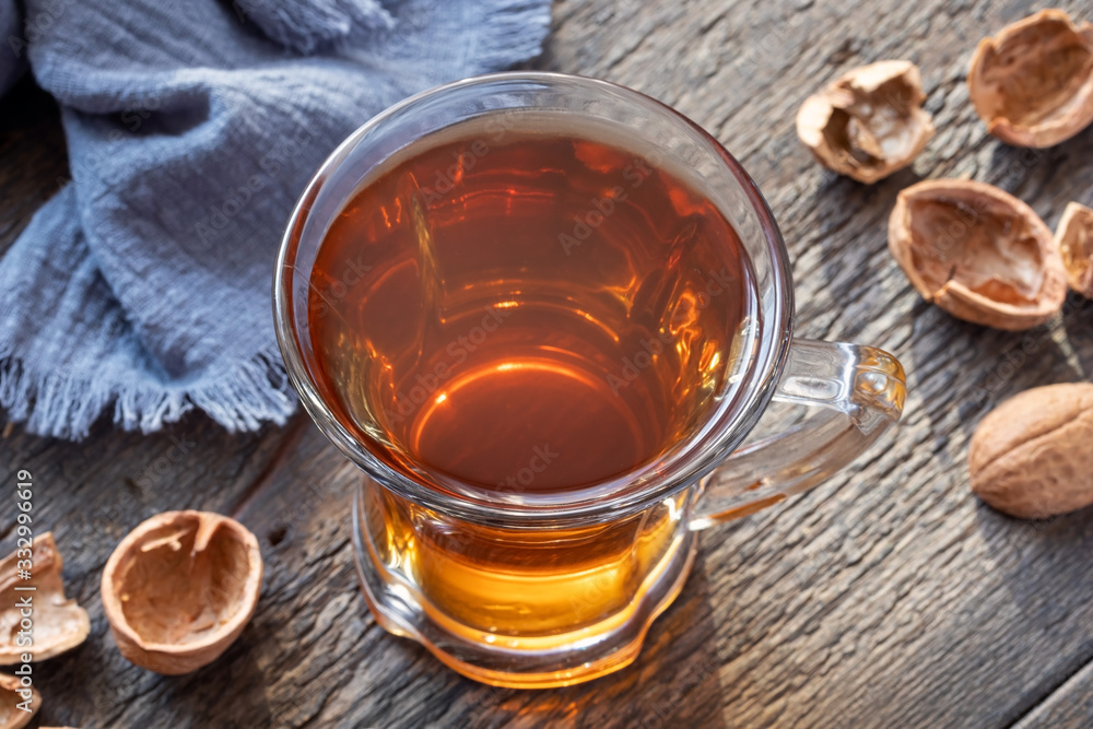 A cup of herbal tea made from walnut shells - folk remedy for cough A cup of herbal tea made from walnut shells - folk remedy for cough