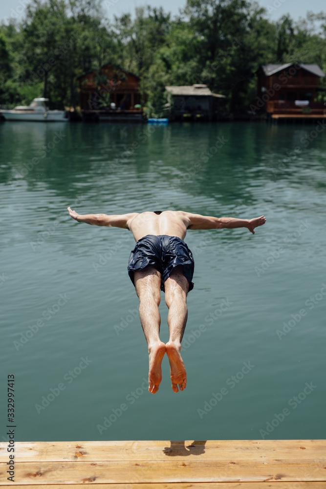 Man having fun jumping in water Man having fun jumping in water