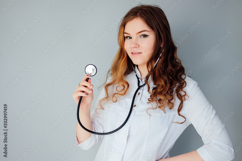 Young woman doctor in a white coat and medical mask. The medicine Young woman doctor in a white coat and medical mask. The medicine