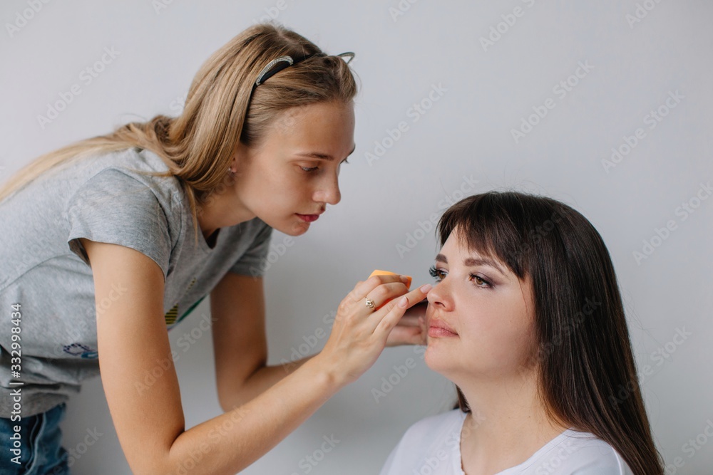 Make up artist working with real woman client Make up artist working with real woman client