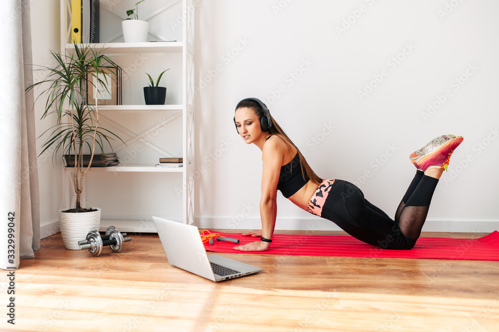 Fitness at home. Slender woman is training Fitness at home. Slender woman is training