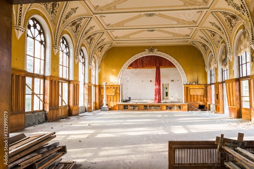 Old abandoned sovet hall show stage with red curtains and SSRS star on top. Architecture and interior details of soviet union buildings. photo