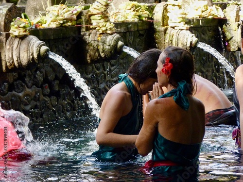 People bathing in holy springs of Kira Empul, Sacred Pool of Purification, Ubud, Bali, Indonesia