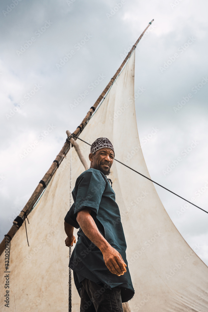 Portrait of a fisherman in his sailing boat. He is looking at th Portrait of a fisherman in his sailing boat. He is looking at th