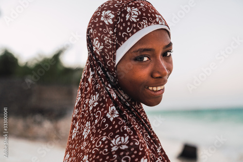 muslim girl in Zanzibar, Tanzania Wearing a flowery hiyab photo