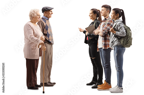 Group of students talking to an edlerly man and woman photo