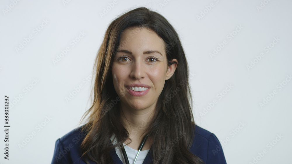 Portrait of beautiful nurse smiling while wearing scrubs and stethoscope Portrait of beautiful nurse smiling while wearing scrubs and stethoscope