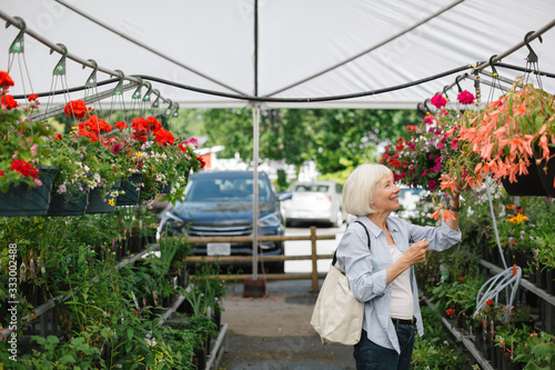 Mature woman shopping at plant market.