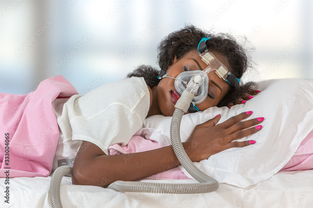 © JPC-PROD - Woman wearing CPAP headgear to sleep against apnea © JPC-PROD - Woman wearing CPAP headgear to sleep against apnea