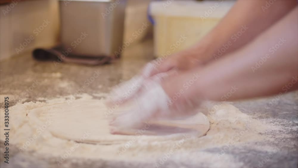 Real pepperoni pizza, cooking method, Italian makes real Italian pizza from dough with fingers, placing pizza in a wood-burning pizza oven using a pizza peel Real pepperoni pizza, cooking method, Italian makes real Italian pizza from dough with fingers, placing pizza in a wood-burning pizza oven using a pizza peel