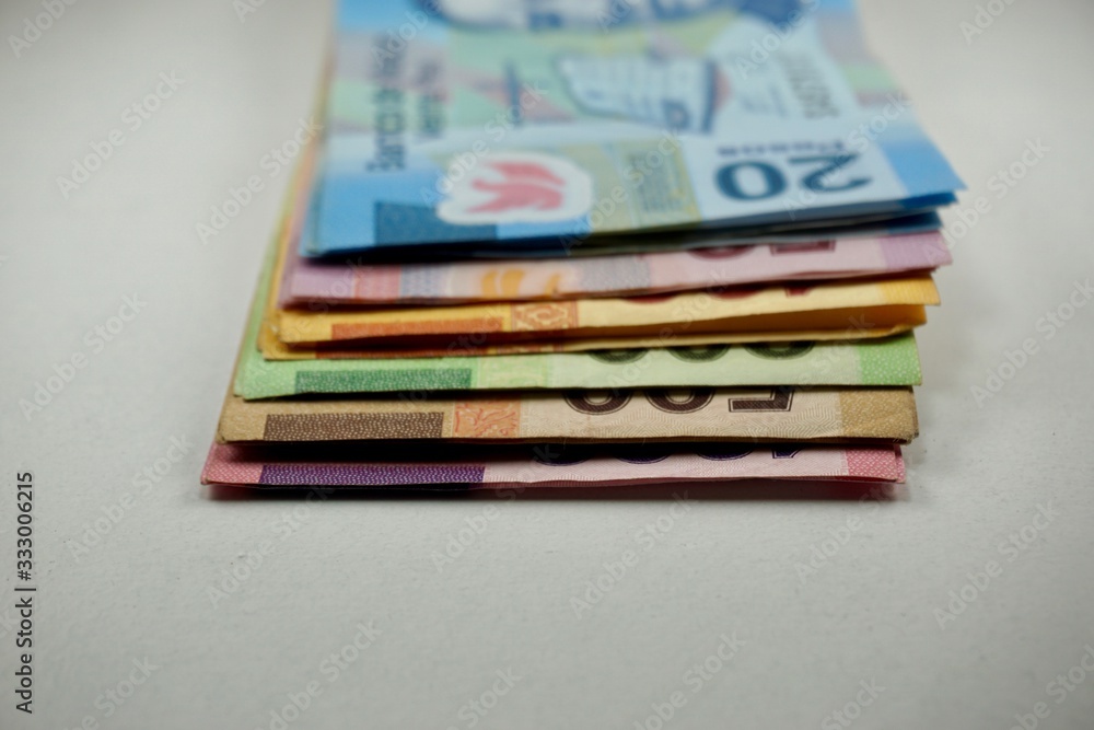 Many mexican pesos bills spread over a surface