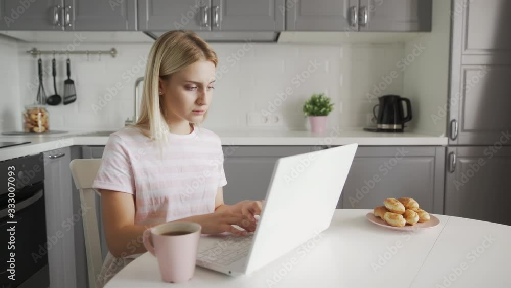 Business woman typing on a laptop while sitting at the table Business woman typing on a laptop while sitting at the table