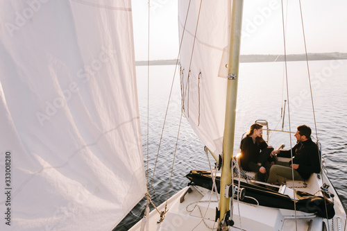 Couple in sailboat on lake photo