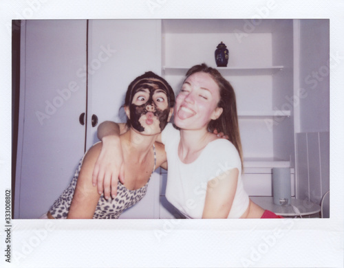 Best friends have fun with face masks.