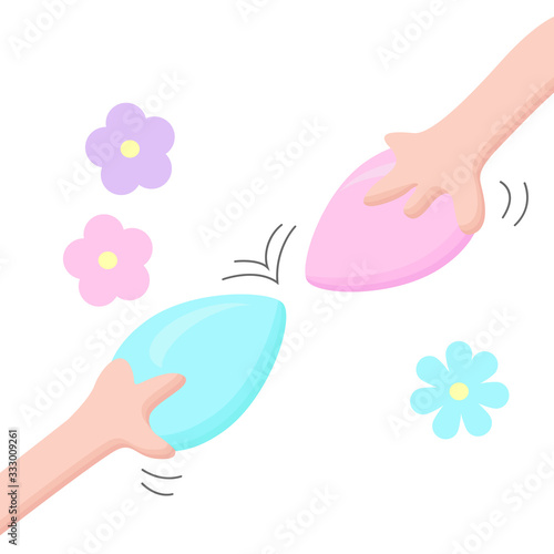 Two hands hold eggs to fight whose egg is stronger. Multi-colored Easter eggs.